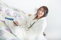 Beautiful young girl listening to music in her bed Royalty Free Stock Photo