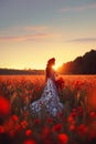 A beautiful young girl in a long dress stands in a poppy field. Royalty Free Stock Photo