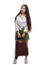 Beautiful young girl with long hair with a backpack in her hands. Smiling brunette in a white shirt and green shorts. Isolated on Royalty Free Stock Photo