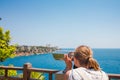 Beautiful and young girl looking through binoculars