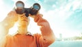 Beautiful Young Girl Looking Through Binoculars At The Sea On A Bright Sunny Day. Travel Holidays Journey Concept Royalty Free Stock Photo