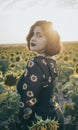 A beautiful young girl is looking at the camera dressed in her sunflower shirt Royalty Free Stock Photo