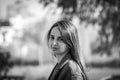 Beautiful young girl looking at the camera outdoors. Black and white photo Royalty Free Stock Photo