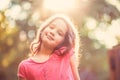 Beautiful young girl looking at camera and smiling on sunny day