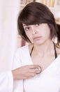 Beautiful young girl looking nervous at the doctor Royalty Free Stock Photo