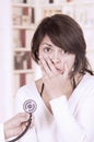 Beautiful young girl looking nervous at the doctor Royalty Free Stock Photo