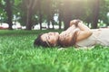 Beautiful young girl lying on grass in summer park Royalty Free Stock Photo