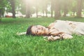 Beautiful young girl lying on grass in summer park Royalty Free Stock Photo