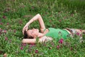 Beautiful young girl lying on green grass Royalty Free Stock Photo