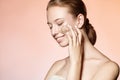 Beautiful young girl massages the face scrub and smiles