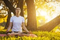 Beautiful young girl meditating in autumn park Royalty Free Stock Photo