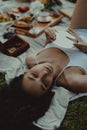 Beautiful young girl with mirror at picnic