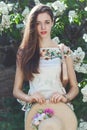 Beautiful young girl model posing near blooming lilacs at spring Royalty Free Stock Photo