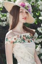 Beautiful young girl model posing near blooming lilacs at spring Royalty Free Stock Photo