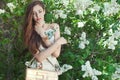 Beautiful young girl model posing near blooming lilacs at spring Royalty Free Stock Photo