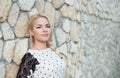 Beautiful young girl near a stone wall Royalty Free Stock Photo