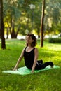 Beautiful young girl in park practices yoga and relaxes. Calm and tranquility Royalty Free Stock Photo