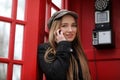 Beautiful young girl in a phone booth. The girl is talking on th Royalty Free Stock Photo