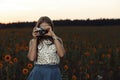 Beautiful young girl photographer with photo camera on nature Royalty Free Stock Photo