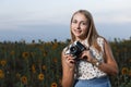 Beautiful young girl photographer with photo camera on nature Royalty Free Stock Photo