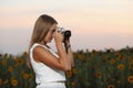 Beautiful young girl photographer with photo camera on nature Royalty Free Stock Photo