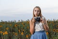 Beautiful young girl photographer with photo camera on nature Royalty Free Stock Photo