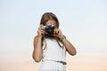 Beautiful young girl photographer with photo camera on nature Royalty Free Stock Photo