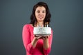 Beautiful young girl in a pink dress holds a cake in her hands with burning candles, close-up. Happy birthday congratulation Royalty Free Stock Photo