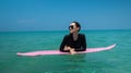 Beautiful young girl with pink surfboard during summer holidays Royalty Free Stock Photo