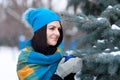 Beautiful young girl portrait on winter background. A charming young lady walking in a winter forest. Attractive woman with Cup. Royalty Free Stock Photo