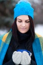 Beautiful young girl portrait on winter background. A charming young lady walking in a winter forest. Attractive woman with Cup. Royalty Free Stock Photo