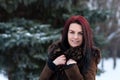 Beautiful young girl portrait on winter background. Charming young lady walking in a winter forest. Attractive woman posing. Royalty Free Stock Photo