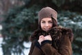 Beautiful young girl portrait on winter background. Charming young lady walking in a winter forest. Attractive woman posing. Royalty Free Stock Photo