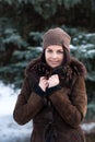 Beautiful young girl portrait on winter background. Charming young lady walking in a winter forest. Attractive woman posing. Royalty Free Stock Photo