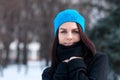 Beautiful young girl portrait on winter background. Charming young lady walking in a winter forest. Attractive woman posing. Royalty Free Stock Photo