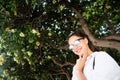 Beautiful young girl posing on the background of evergreen tree Royalty Free Stock Photo