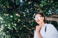 Beautiful young girl posing on the background of evergreen tree Royalty Free Stock Photo