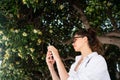 Beautiful young girl posing on the background of evergreen tree Royalty Free Stock Photo