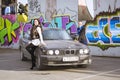 Beautiful young girl posing about BMW-car 5-series, e34 Royalty Free Stock Photo