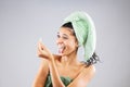 Beautiful young girl posing with towels after having a bath, holding cotton ear stick. Funny disgusted face expression Royalty Free Stock Photo