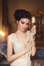 A beautiful young girl in a powdery wedding dress on the background of the interiors of a luxurious historical apartment. Royalty Free Stock Photo