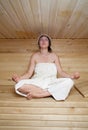 Beautiful young girl practicing yoga at sauna Royalty Free Stock Photo