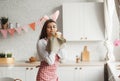 A beautiful young girl in rabbit ears holds an Easter cake in her hands, sniffs a pleasantly smelling freshly baked cake Royalty Free Stock Photo