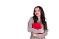 A beautiful young girl with red lips holds a red notebook in her hands. student. businesswoman on isolated isolated white