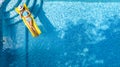 Beautiful young girl relaxing in swimming pool, swims on inflatable mattress and has fun in water on family vacation Royalty Free Stock Photo