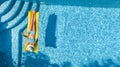 Beautiful young girl relaxing in swimming pool, swims on inflatable mattress and has fun in water on family vacation Royalty Free Stock Photo