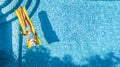 Beautiful young girl relaxing in swimming pool, swims on inflatable mattress and has fun in water on family vacation Royalty Free Stock Photo