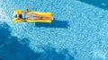 Beautiful young girl relaxing in swimming pool, woman swims on inflatable mattress and has fun in water on family vacation Royalty Free Stock Photo