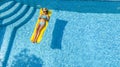 Beautiful young girl relaxing in swimming pool, woman swims on inflatable mattress and has fun in water on family vacation Royalty Free Stock Photo