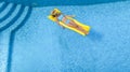 Beautiful young girl relaxing in swimming pool, woman swims on inflatable mattress and has fun in water on family vacation Royalty Free Stock Photo